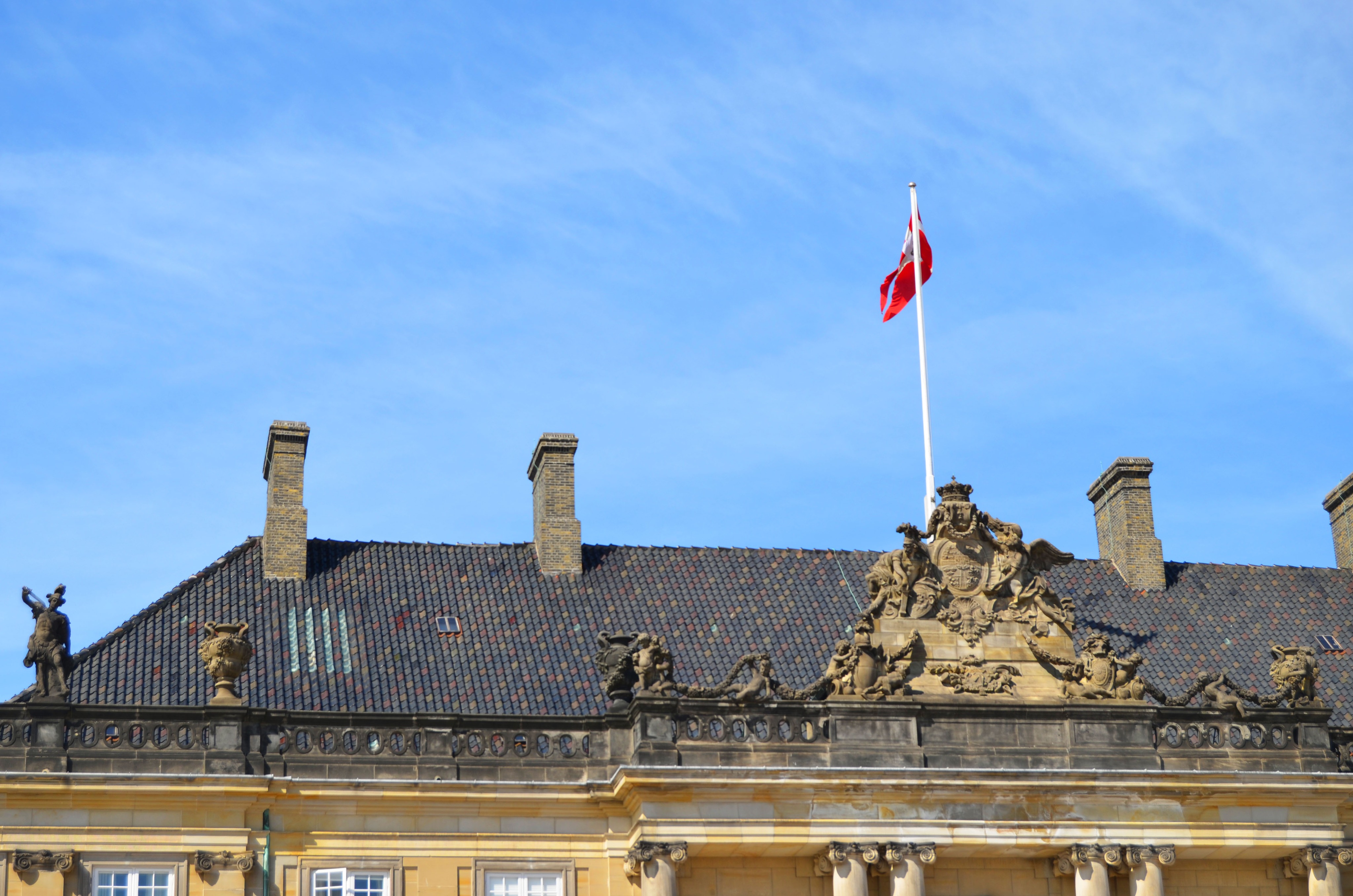 Dannebrog (the danish flag) raised on top of, one of the mansions at Amalienborg